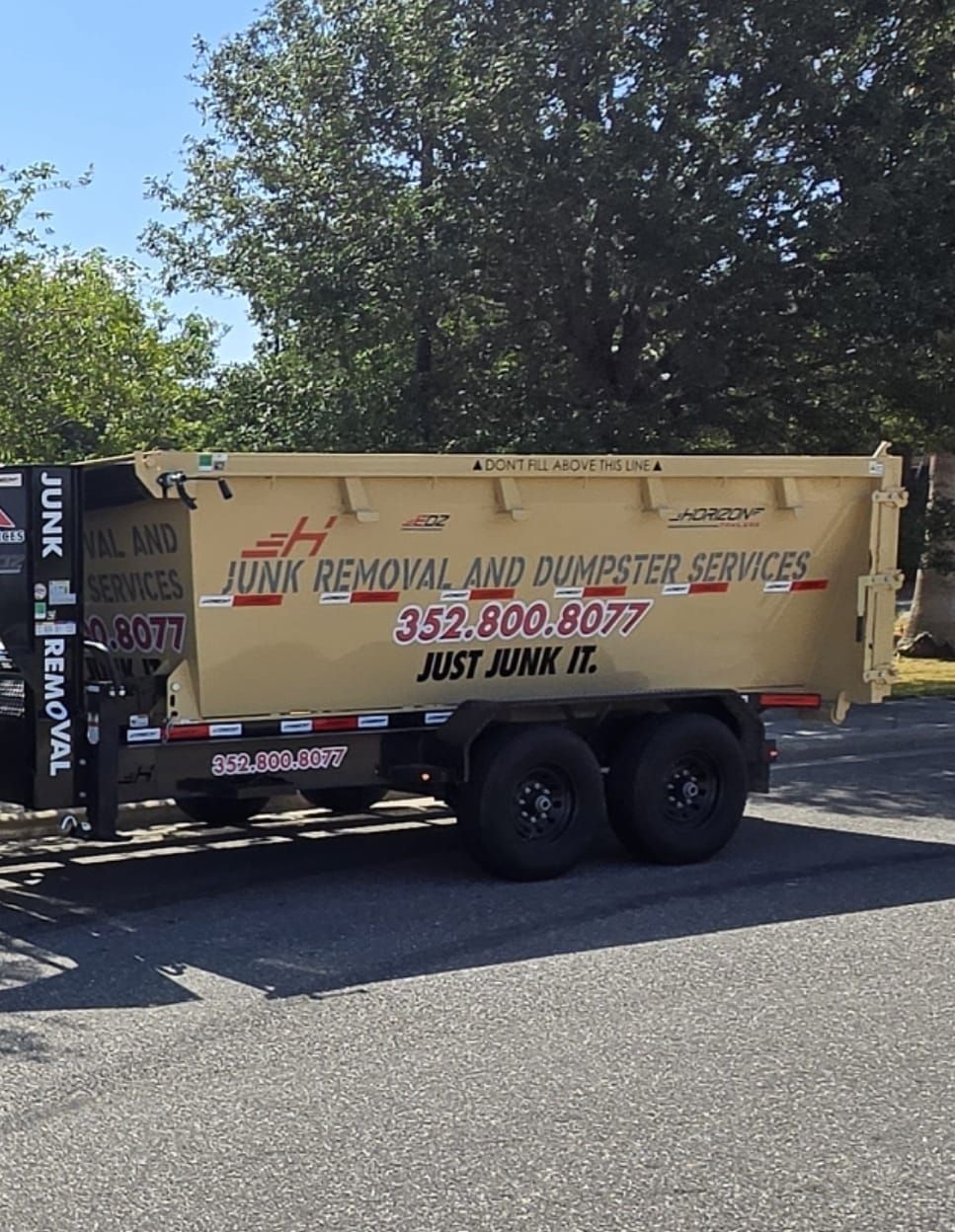 EPM & Services junk removal dumpster trailer parked in Eustis, FL