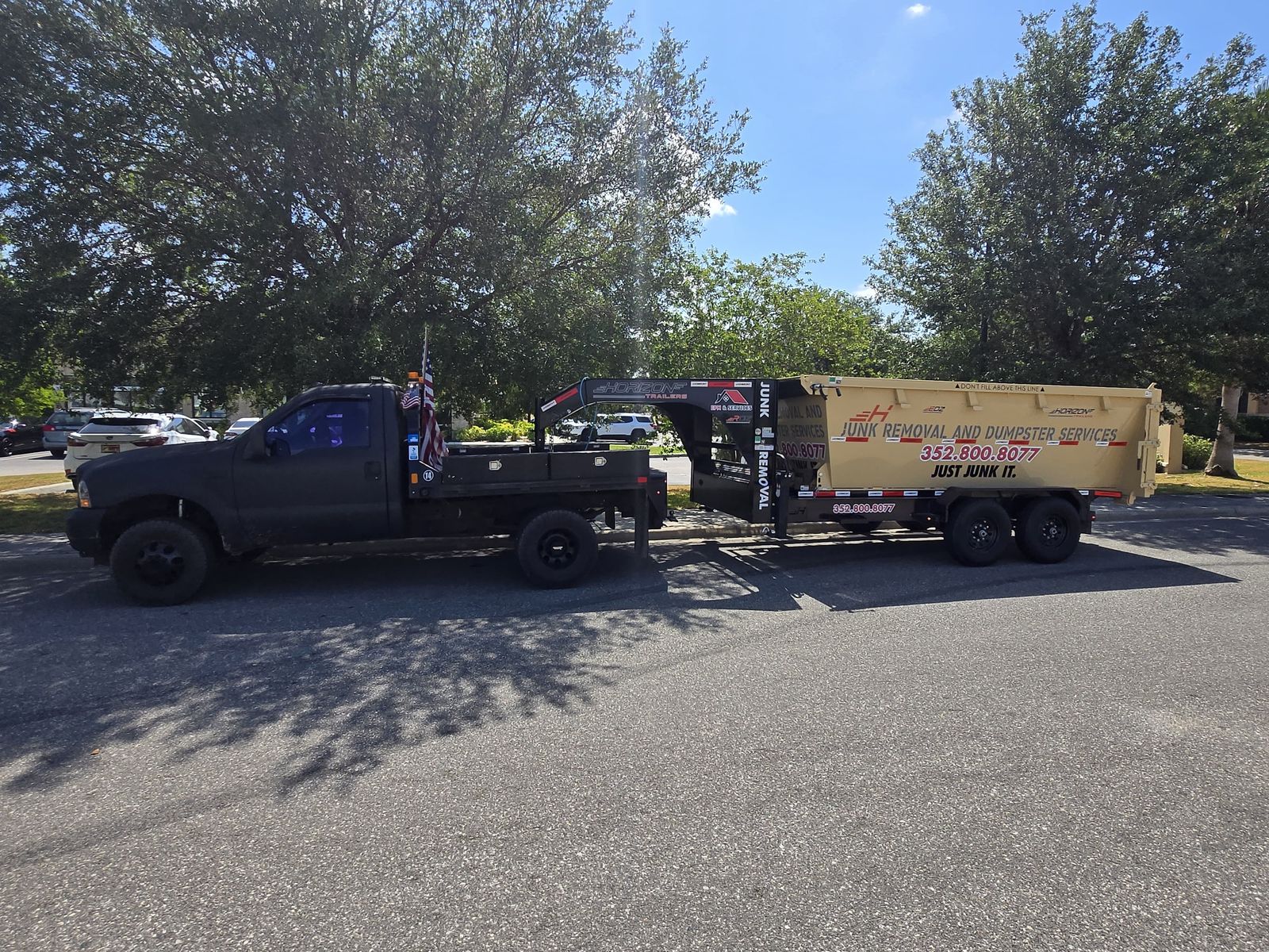 Junk removal dumpster trailer and truck for EPM & Services in Eustis, FL