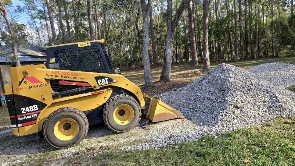 CAT skid steer spreading gravel during yard cleanup in Eustis, Florida